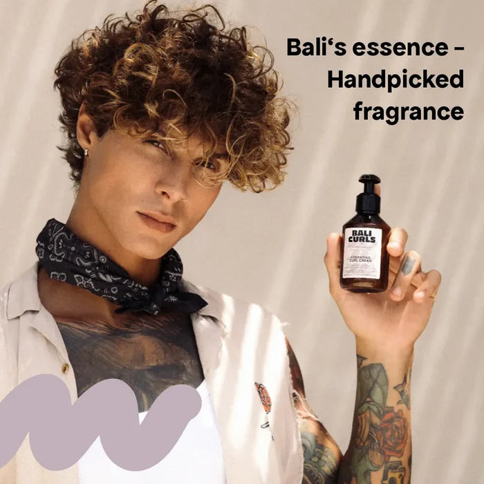 Man with curly hair holding Bali Curls Hydrating Curl Cream, showcasing handpicked fragrance for curls.