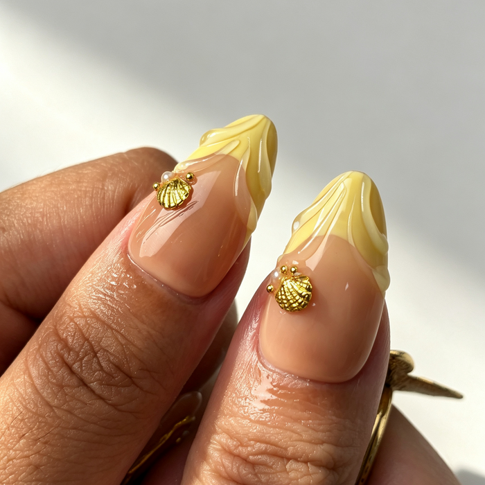 Almond press on nails, yellow french tip, golden shell charm nude fake nails