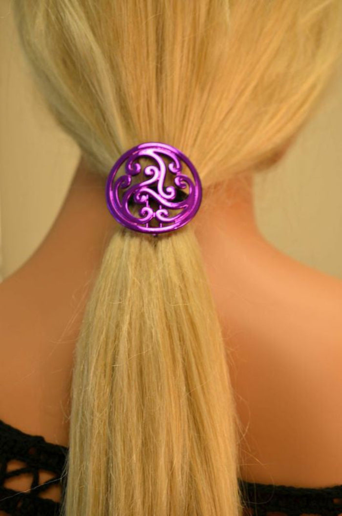 Purple Celtic circle hair hook securing blonde ponytail, rear view