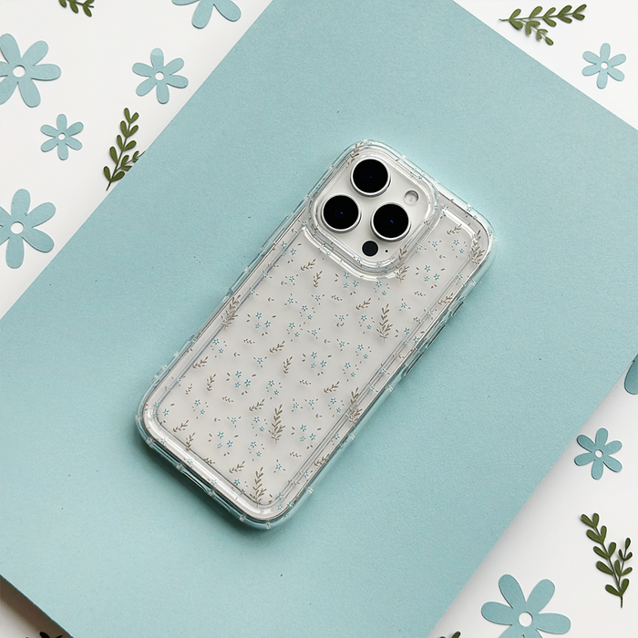 Clear phone case with blue floral pattern on blue paper, surrounded by matching floral and leaf designs.