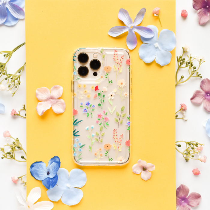 Clear phone case with pastel wildflower pattern, featuring soft floral designs on a transparent background.