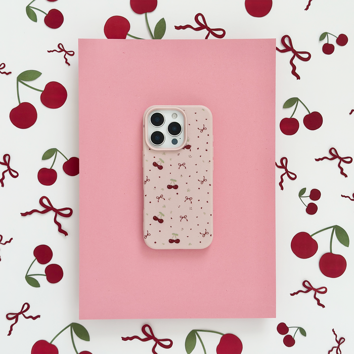 Pink Coconut Lane phone case with small cherry and bow pattern.