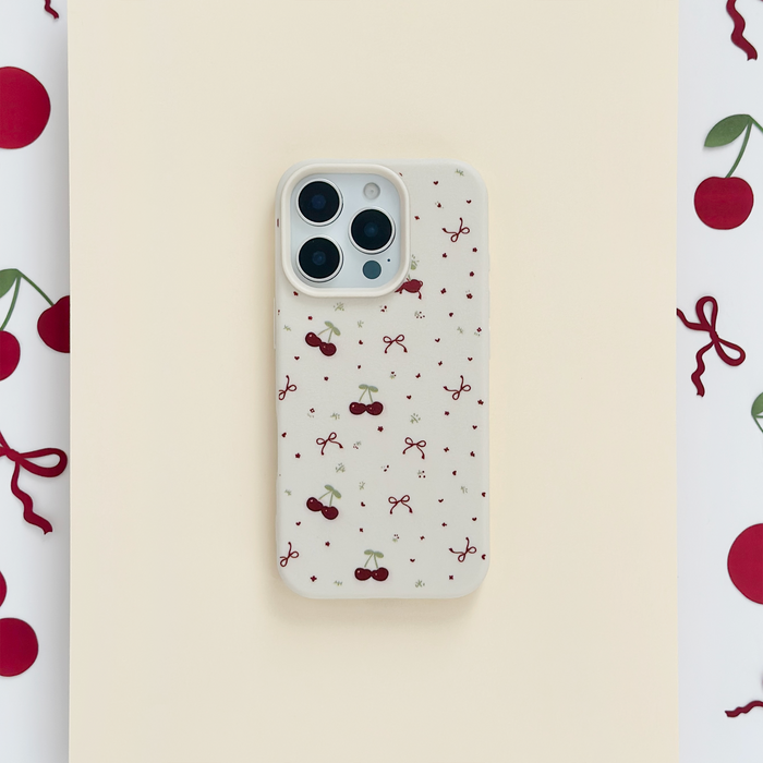White phone case with small red cherries and pink bows pattern by Coconut Lane.