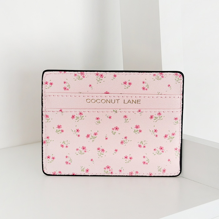 Pink card holder with a ditsy floral pattern by Coconut Lane on a plain white background.