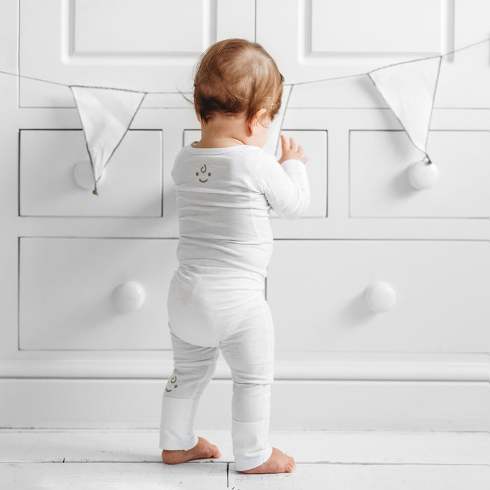 Baby wearing Dreamskin eczema leggings with foldaway feet