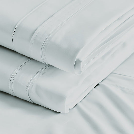 A folded white Egyptian cotton sheet with detailed stitching.