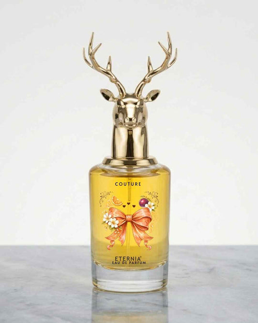 Eternia® Couture eau de parfum bottle with gold deer antler cap, yellow-gold liquid