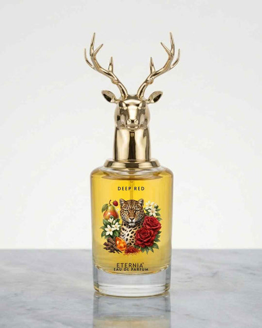 Eternia Deep Red eau de parfum bottle with gold deer antler cap, floral label