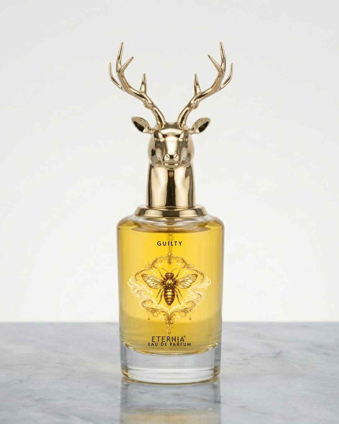Eternia Guilty eau de parfum bottle with gold deer antler cap, amber glass