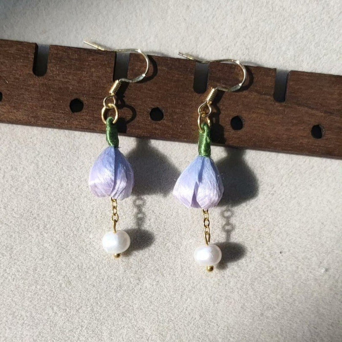 3D silk velvet floral earrings featuring purple buds and green stems, made using traditional artisanal Ronghua techniques.