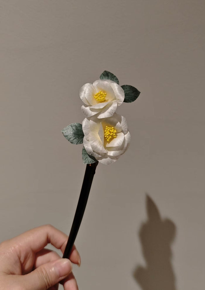 Handheld handmade Ronghua camellia flower hair accessory with two white flowers and green leaves