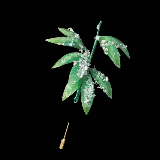 Handcrafted Snow Bamboo Ronghua brooch featuring green silk velvet leaves with white snow-like accents on a black lapel.