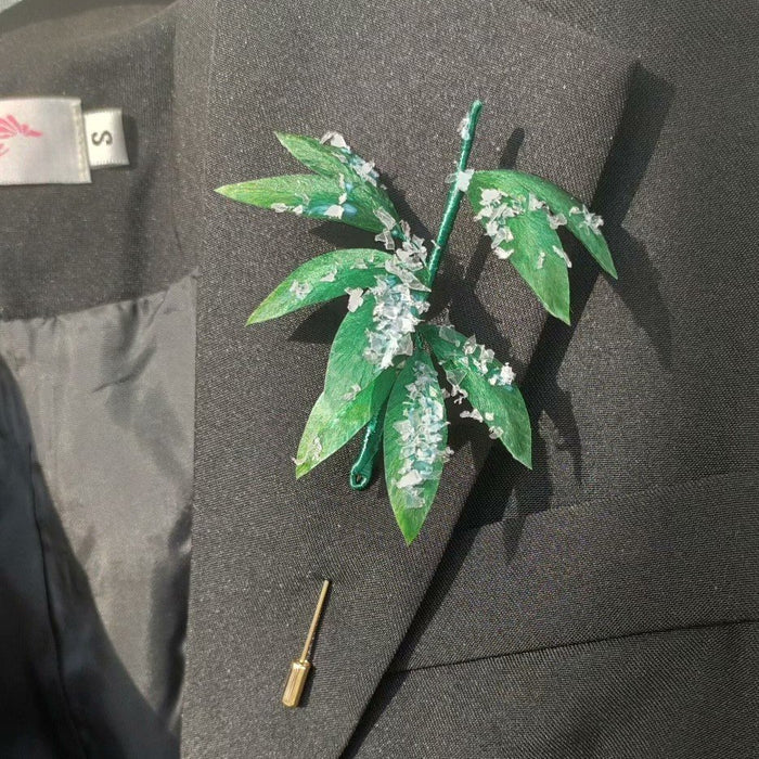 3D silk velvet botanical lapel pin depicting bamboo leaves covered in snow, made with traditional artisanal Ronghua techniques.