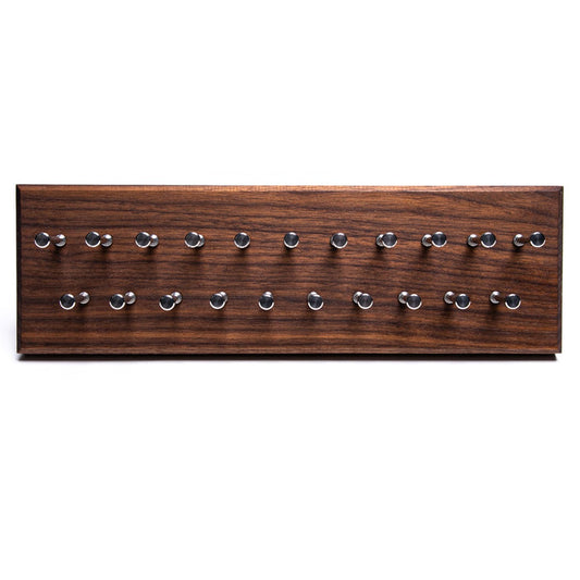 A KirbyAllison.com Solid Hardwood Board with a lot of Hanger Project Small Tie Rack - Walnut/Stainless Steel Pegs on it, perfect for a small tie rack or hanger project.
