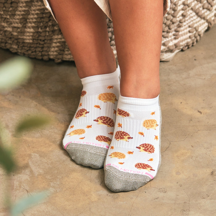 Ankle socks featuring a hedgehog pattern with a white base and gray toe area.