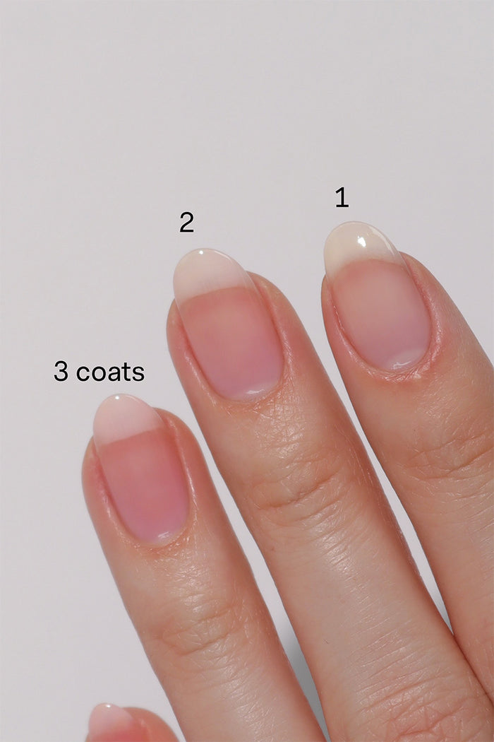 Swatch of Cirque Colors Hint Tint: Blush nail polish applied in 1, 2, and 3 coats. This clear bright pink-tinted polish enhances natural nails with a subtle wash of color, delivering a glossy and ultra-transparent finish for a 'my nails but better' look