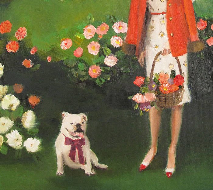 Woman with a dog and flowers in a garden