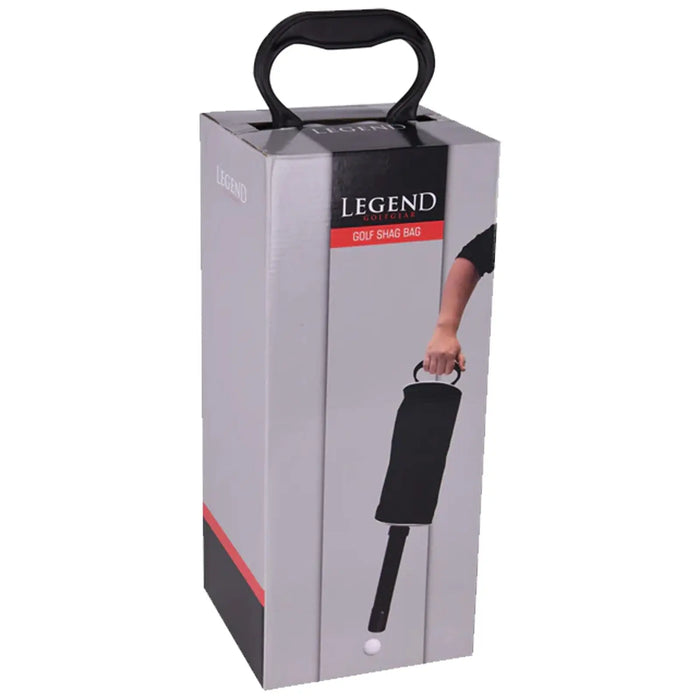 A box labeled Legend Golf Shag Bag is displayed upright with a handle on top while a person's hand is holding the bag containing golf balls against a plain background.