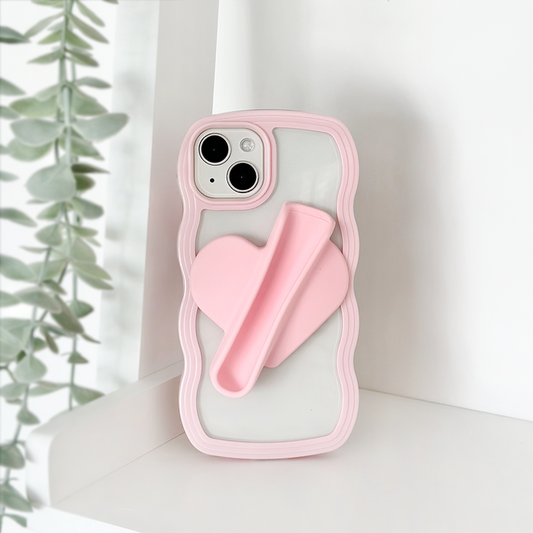 Pink Coconut Lane lip gloss holder sticker and heart-shaped phone grip on a shelf beside green leaves.