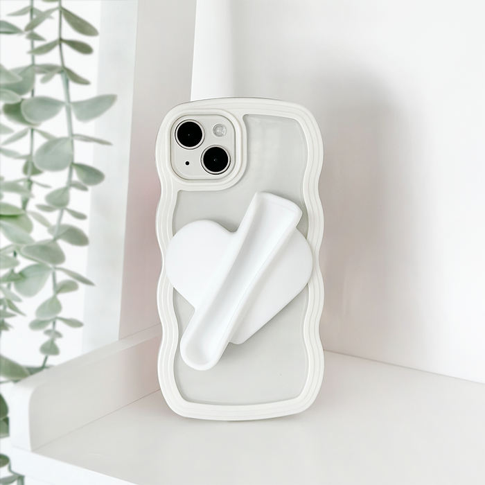 White Coconut Lane lip gloss holder sticker with a wavy-edged heart design attached to a phone case.