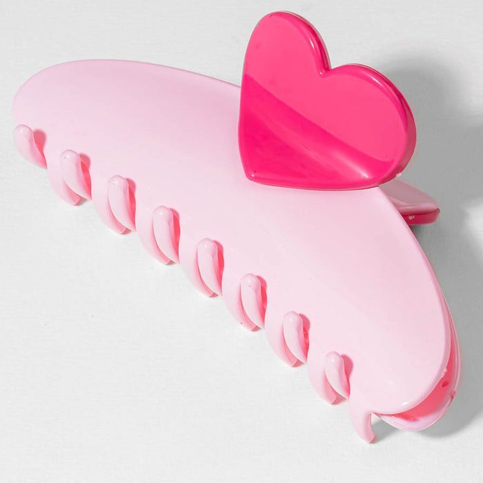 Pink heart-shaped hair clip on a light gray background