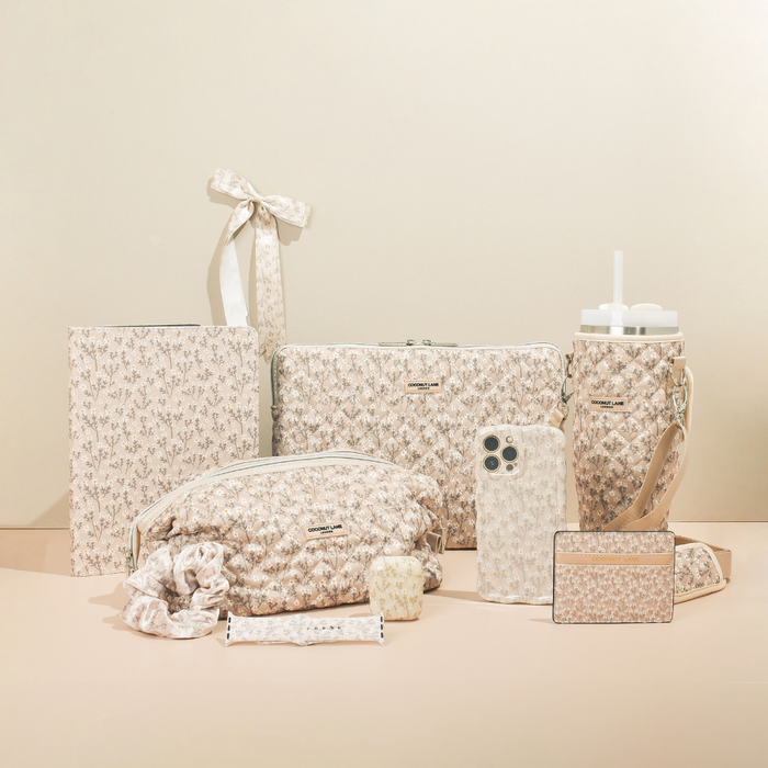Beige accessories with floral patterns, including a card holder and bags from Coconut Lane, displayed together.
