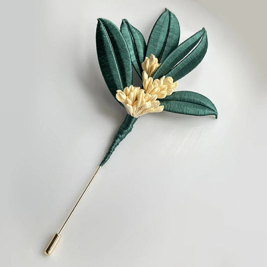 Handmade DIY Osmanthus brooch with green silk leaves and cream flowers, a Chanhua textile craft project with video tutorial.