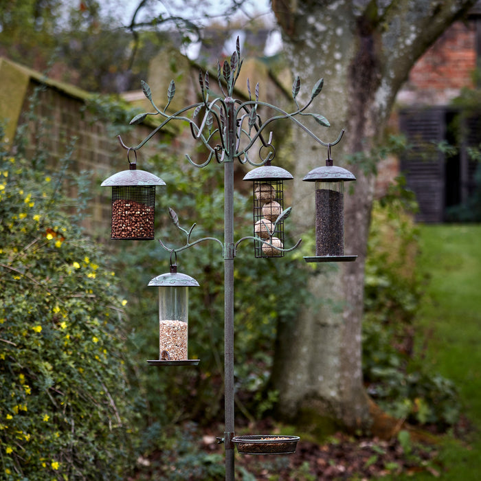 Peckish Secret Garden Dining Station in garden with bird feeders