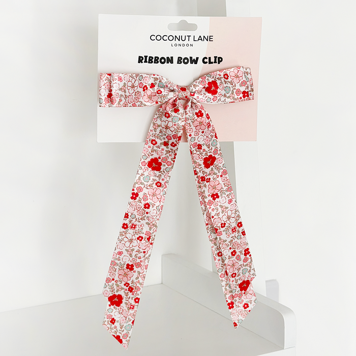 Floral ribbon bow hair clip by Coconut Lane on branded display card, shown against a white background.