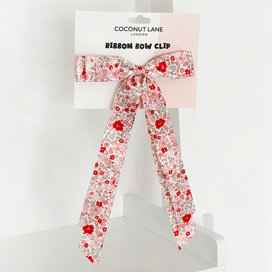 Floral ribbon bow hair clip by Coconut Lane on branded display card, shown against a white background.