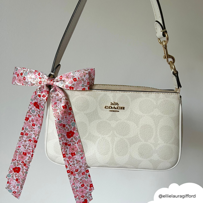 Coconut Lane ribbon bow hair clip with a cute floral pattern on a white background.