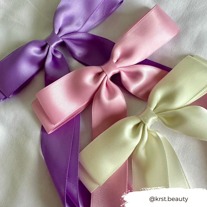 Peony pink ribbon bow hair clip with a soft finish. Text @krst.beauty appears in the image.