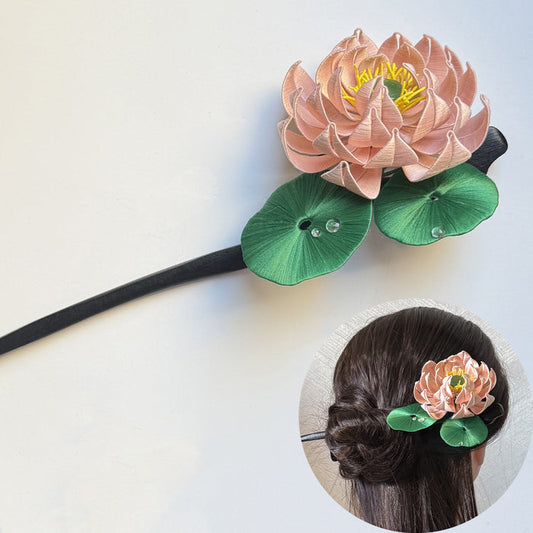 Handmade pink lotus Chanhua hairpin DIY craft kit with round green leaves, dewdrop details, and gold tassel pendant, shown in a styling example.