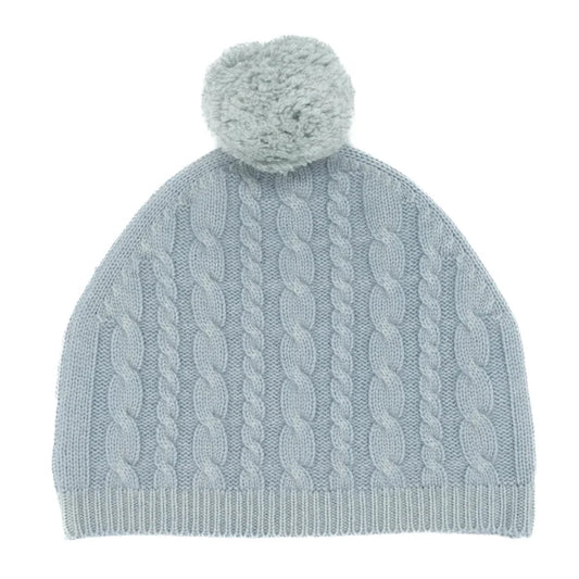 Light blue knitted beanie with a pom-pom on a white background