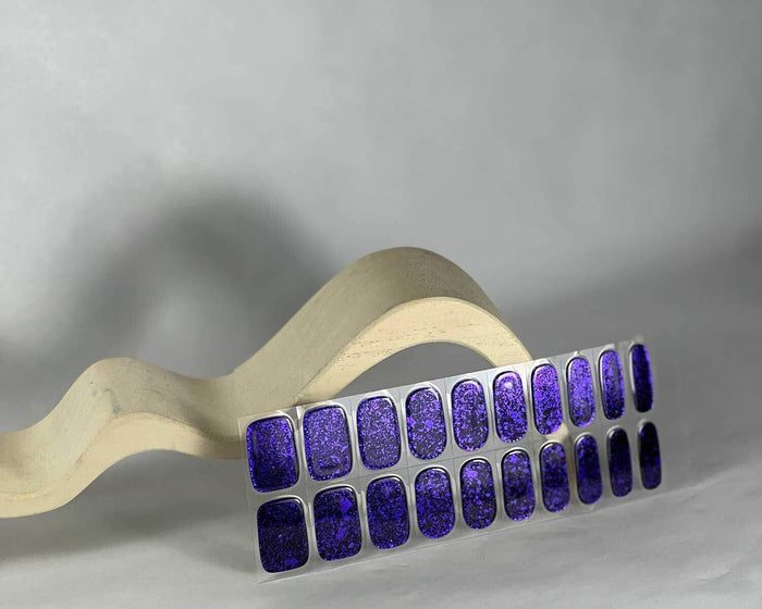 Violet Luster gel nail wraps laid flat, shaped to the nail curve
