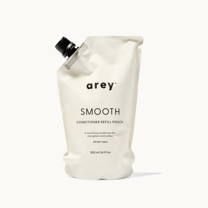 Arey Smooth Conditioner Refill Pouch on a cream background. Label reads: arey. SMOOTH. CONDITIONER REFILL POUCH. A nourishing conditioner that strengthens and softens. All hair types. 500 ml / 16.9 fl oz.