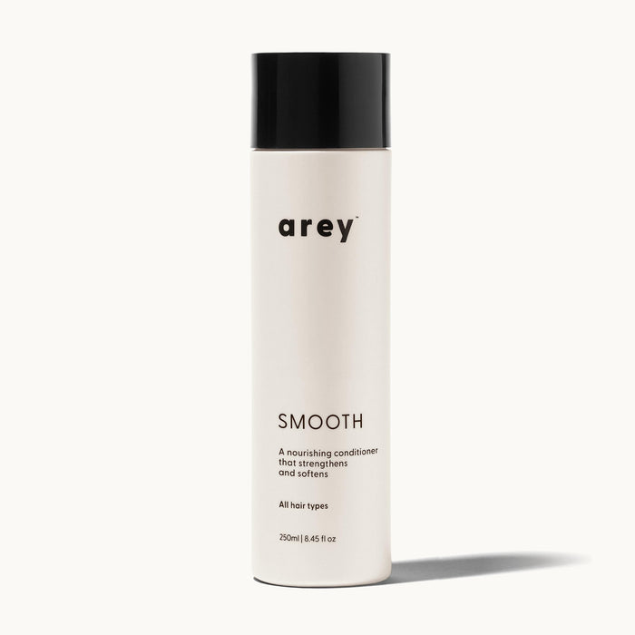 Arey Smooth Conditioner bottle on a cream background. Label reads: arey. SMOOTH. A nourishing conditioner that strengthens and softens. All hair types. 250ml / 8.45 fl oz.