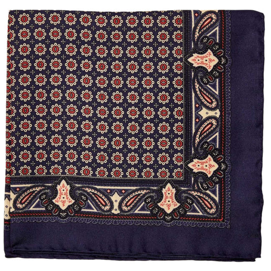 A formal outfit with a Sovereign Grade 100% Silk Navy Pocket Square from KirbyAllison.com featuring a blue paisley pattern on a white background.
