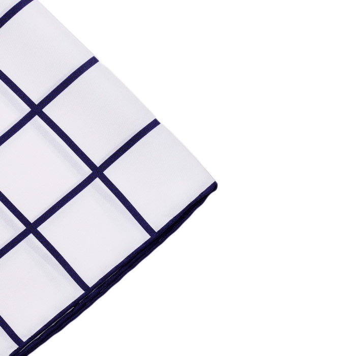 A Sovereign Grade Prince of Wales Pocket Square, White/Navy by KirbyAllison.com on a white surface.