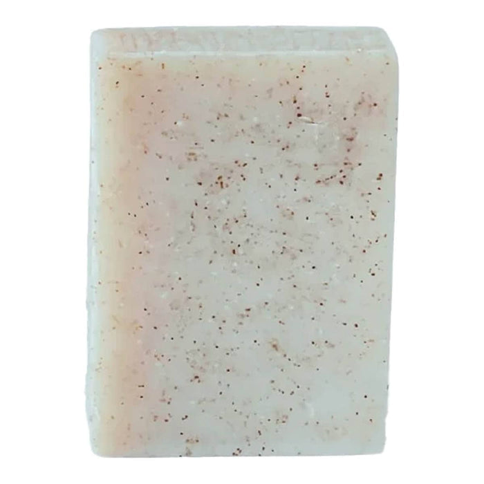 Rectangular citrus scrub bar of soap with speckled texture on a white background