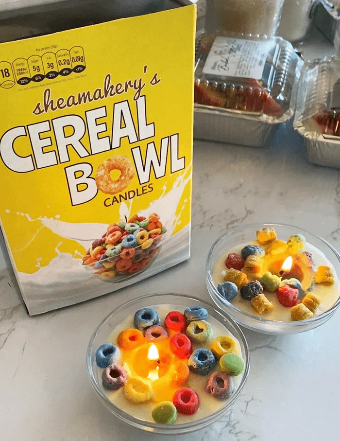 Cereal bowl candles gift set with colorful faux cereal pieces in glass bowls, lit on a counter
