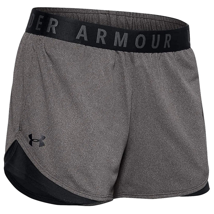 Gray athletic shorts are displayed with a black waistband featuring the text UNDER ARMOUR. The shorts have a loose fit and a lower black panel at the hem.