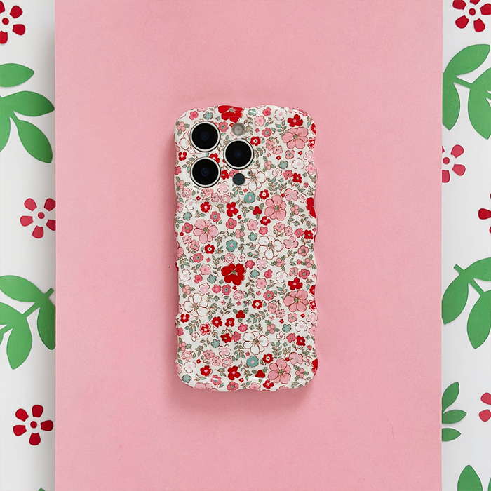 Pink wavy phone case with red and pink flower pattern and green accents.