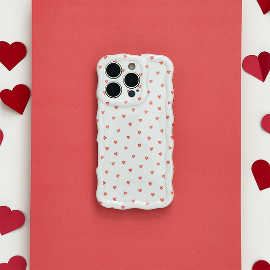 Wavy phone case with mini heart pattern on a red background, surrounded by paper hearts.