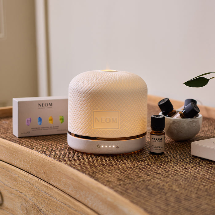 NEOM pod luxe with essential oils on a table